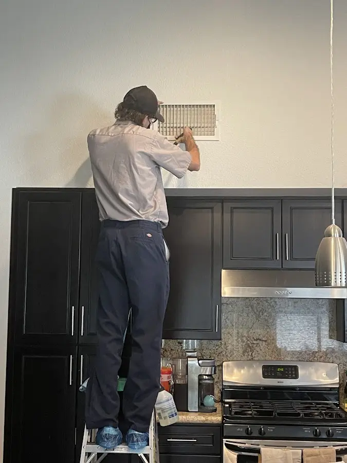 Technician inspecting an air vent during HVAC service in Rohnert Park
